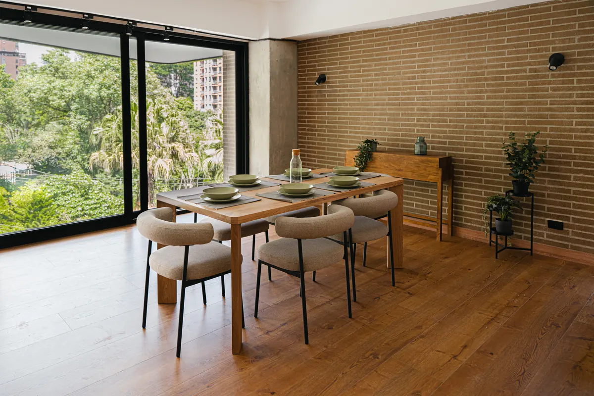 Dining table by the window, looking onto the neighbourhood's foliage