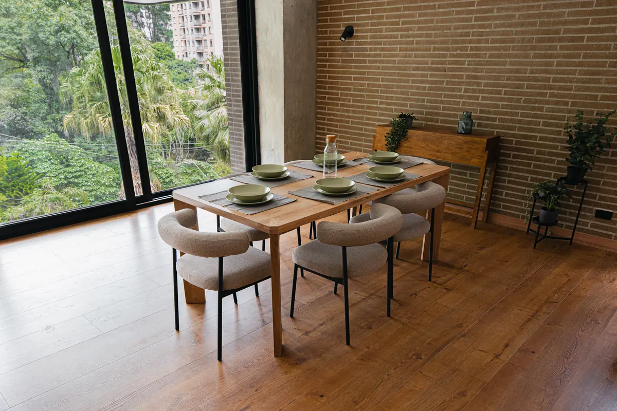 Dining table by the window, looking onto the foliage